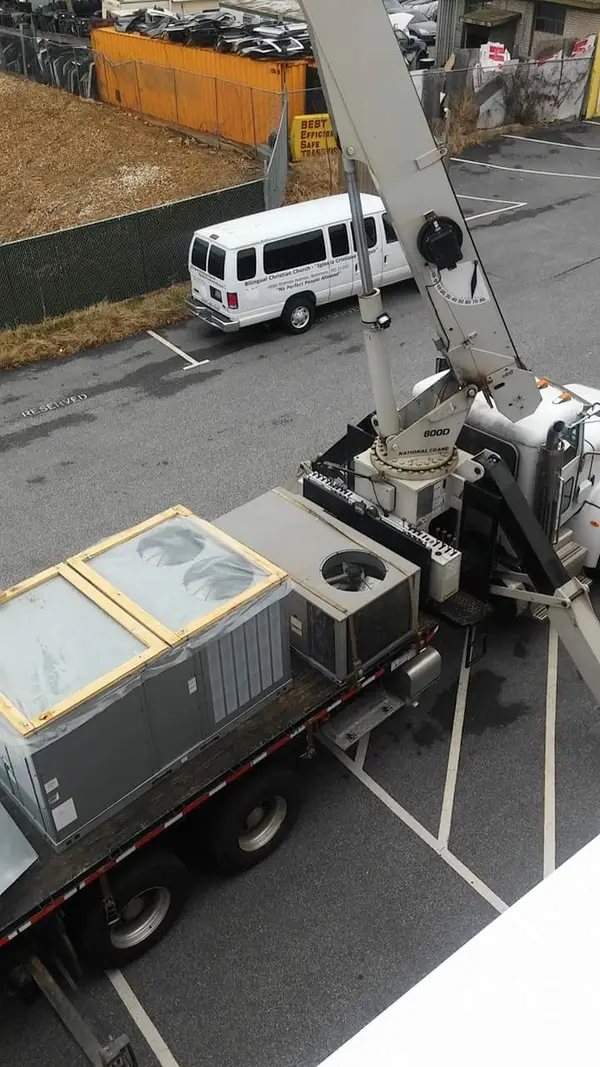 HVAC unit being lifted to a roof