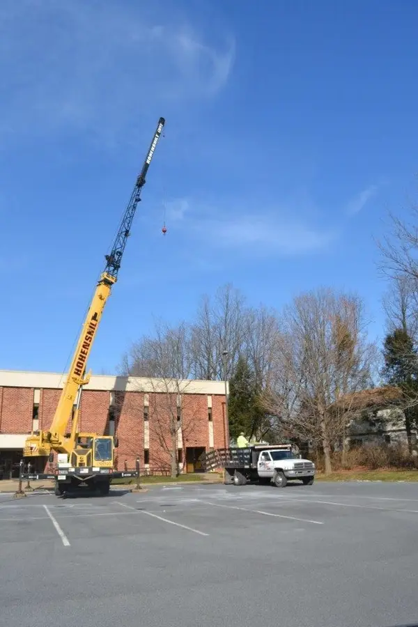 Crane setting rooftop HVAC equipment
