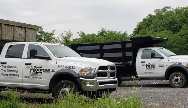 Two branded Git-R-Down tree-service trucks