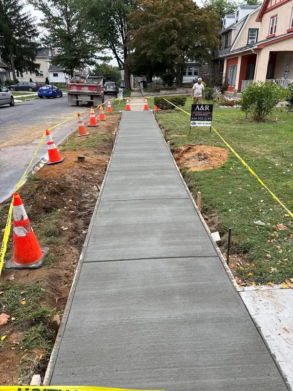Long finished concrete sidewalk by A&R