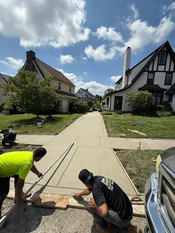Crew finishing a new residential sidewalk for Jerry’s Concrete