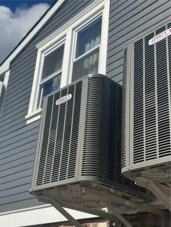 Two outdoor air-conditioning units beside a building