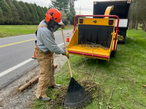 Crew member working beside a chipper