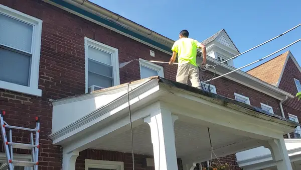 Painter working on an exterior porch
