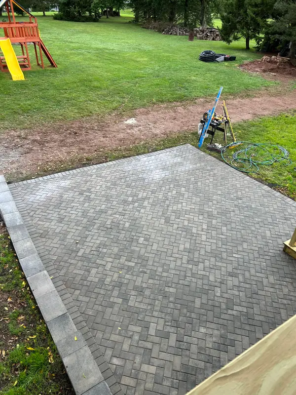 Finished paver patio beside a home