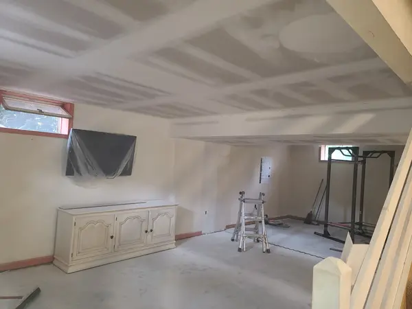 Wide interior with drywall seams being finished