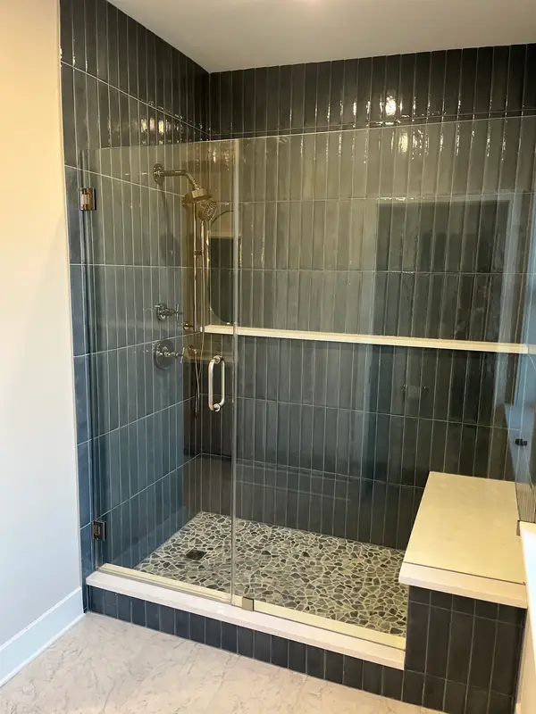 Green tiled shower enclosure
