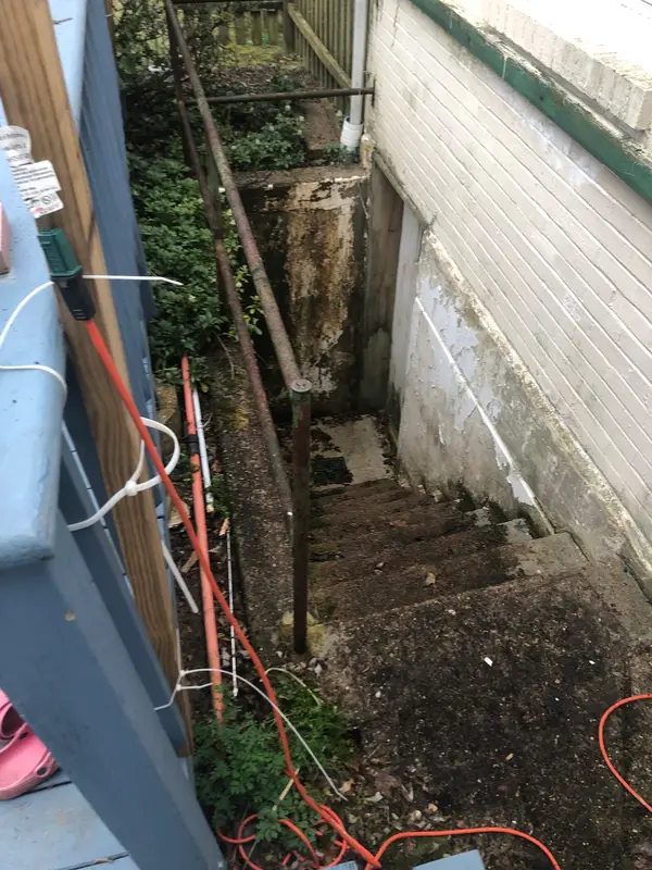 Exterior basement steps before cleaning