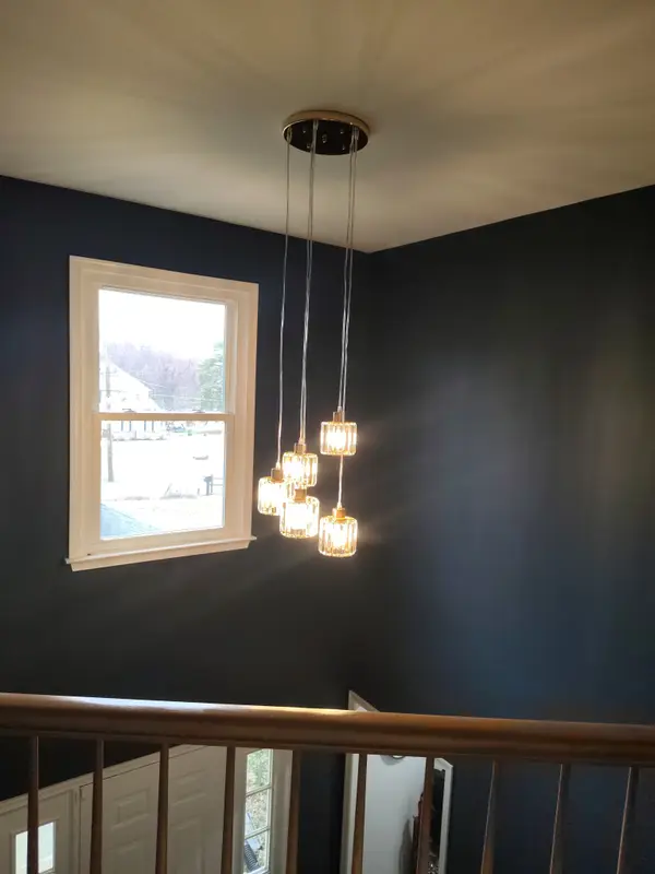 Hanging pendant beside an interior staircase