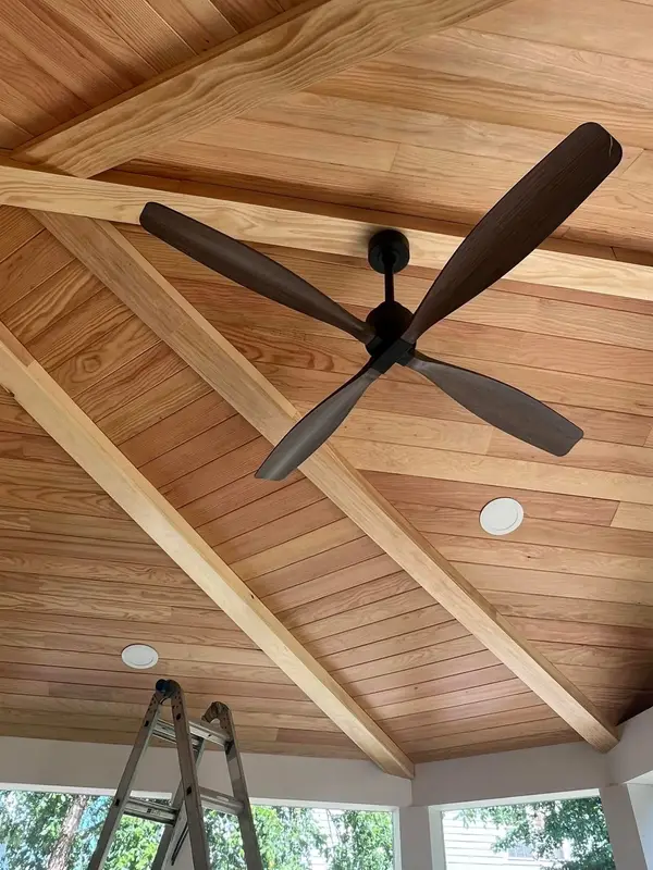 Ceiling fan installed against a wood ceiling