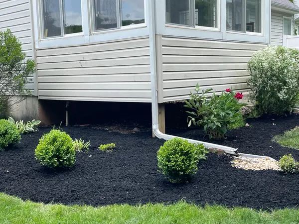 Mulched landscape beds beside a home