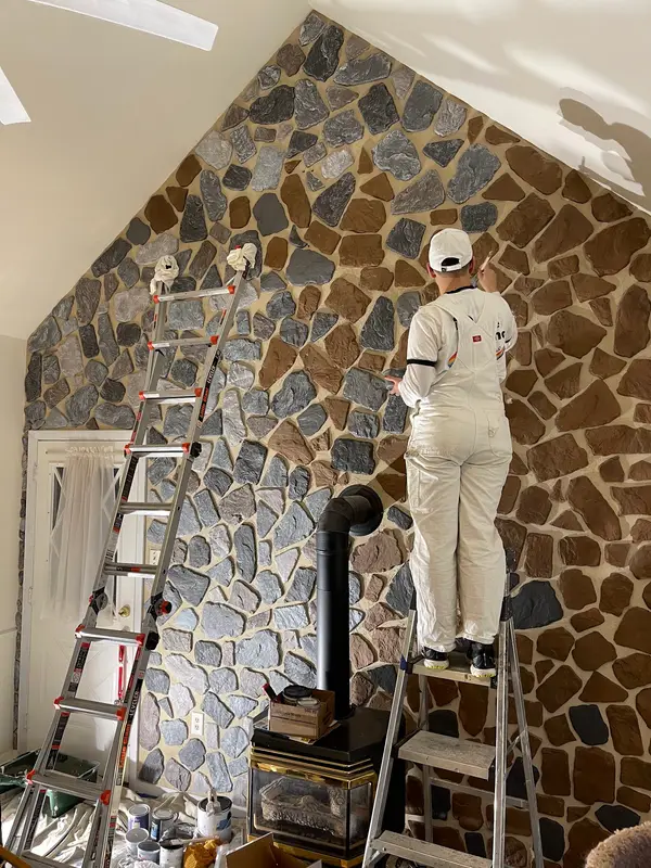 Decorative stone-pattern wall in progress