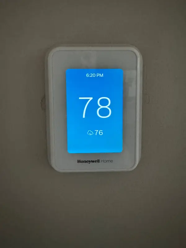Wall thermostat displaying room temperature