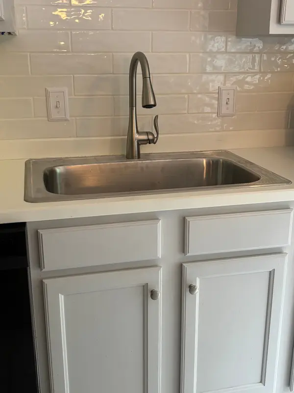 Installed laundry sink and plumbing connections