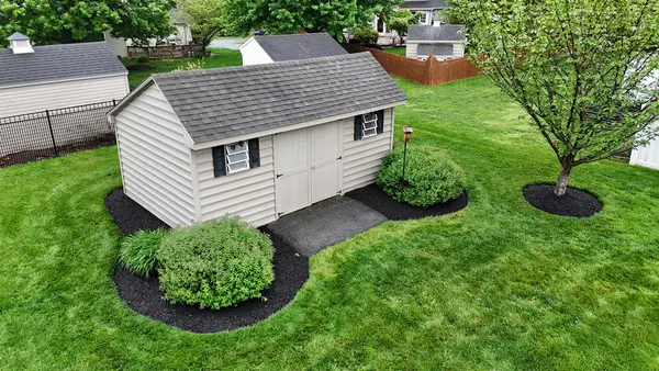 Mulched beds beside a garden shed