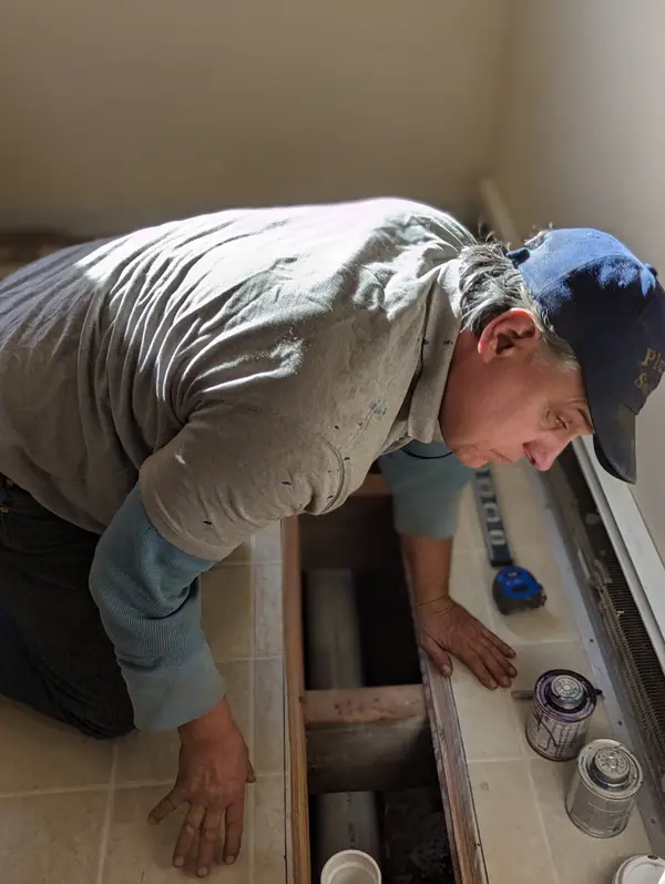 Plumber working on a household fixture