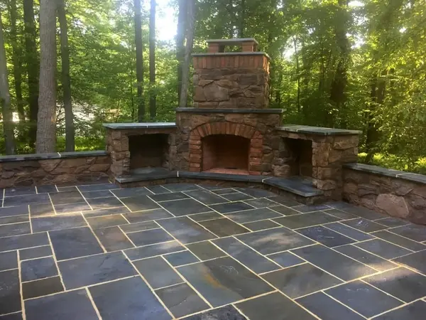 Outdoor stone fireplace and flagstone patio