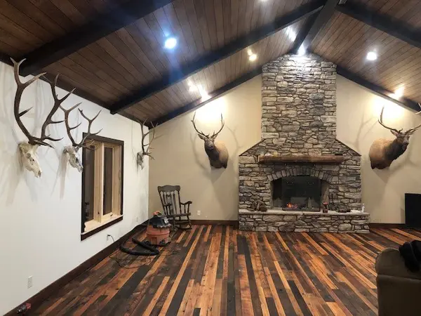 Stone fireplace beneath a wood ceiling