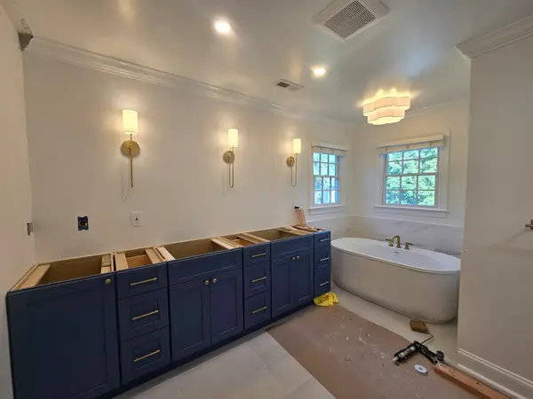 Bathroom with blue vanity and freestanding tub