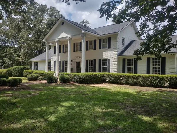 Lawn and shaped shrubs in front of a house