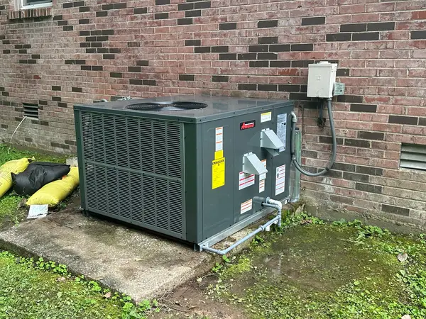 Outdoor HVAC package unit at a brick home