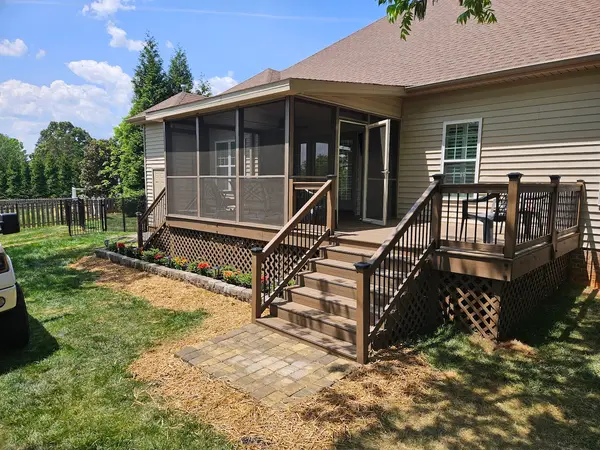 Deck and screened porch beside a house