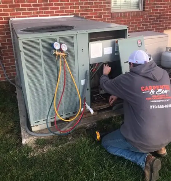 Technician servicing heating and cooling equipment