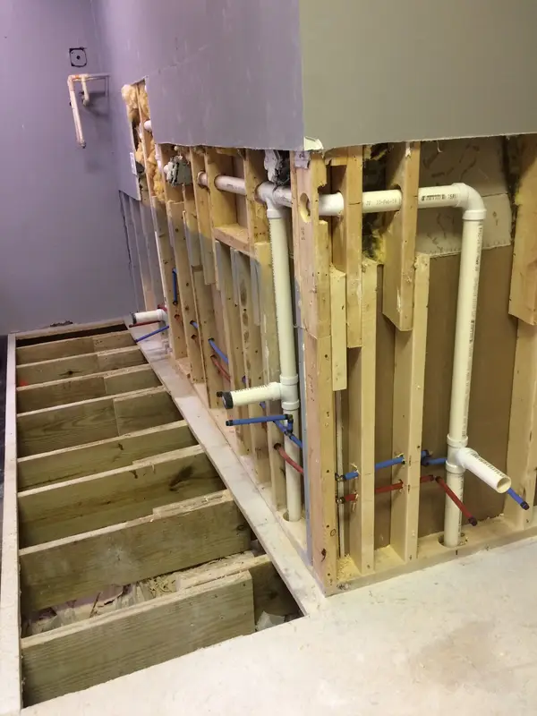 Plumbing rough-in behind wall framing