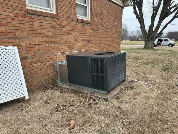 Outdoor condenser beside a house