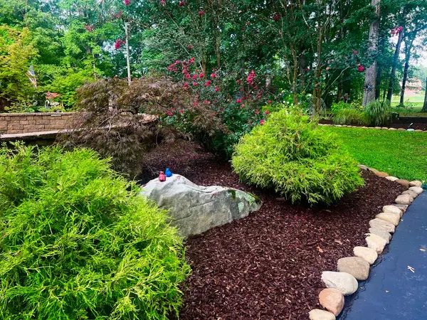 Mulched planting bed with stone edging