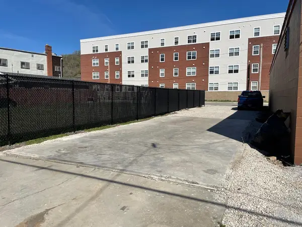 Black fencing along a paved area
