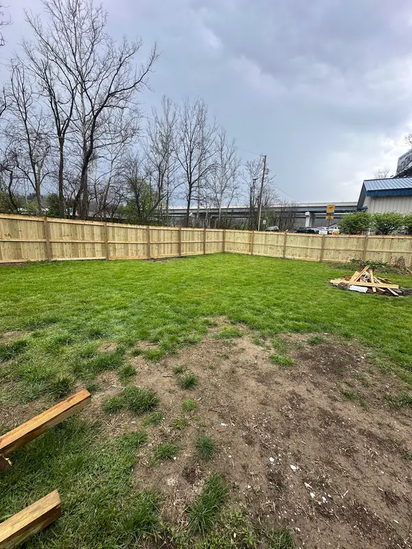 Wood fence across a sloped yard