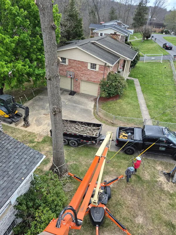 Lift and work truck beside a home