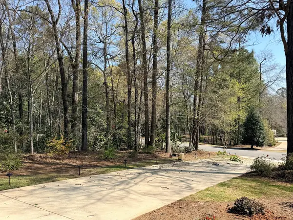 Driveway beside a landscaped property
