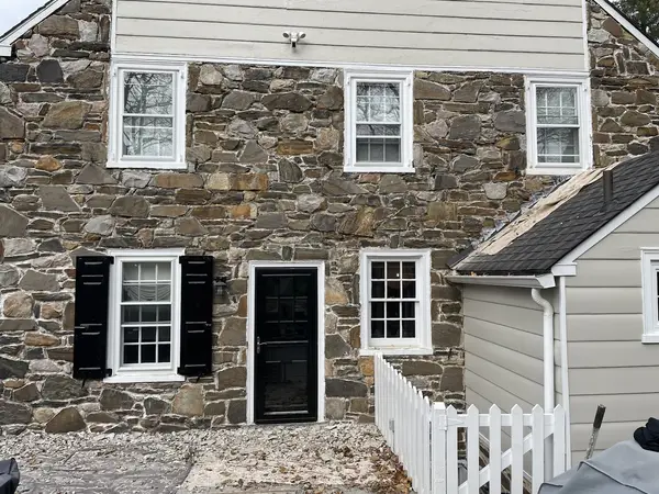 Stone-facing masonry work around windows and an entry