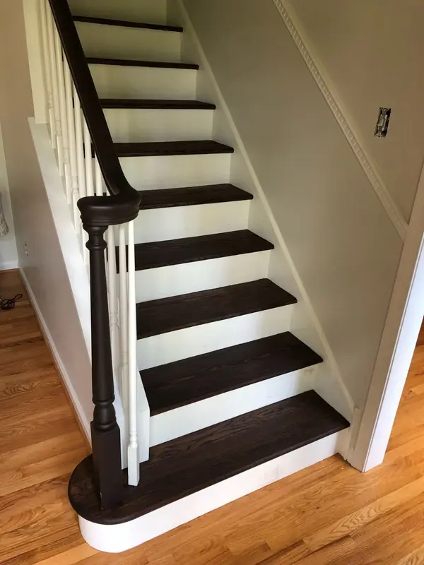 Finished interior staircase with dark treads