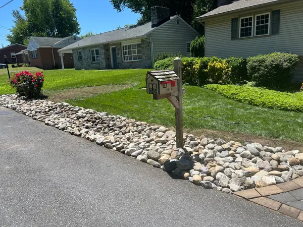 Stone landscape wall along a driveway