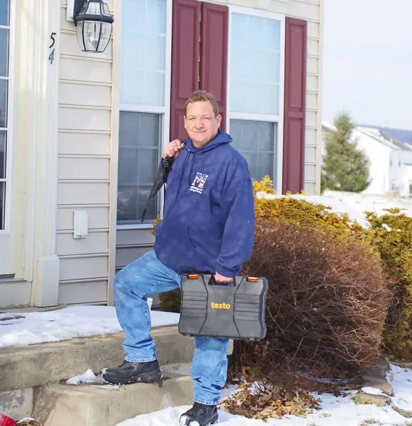 HVAC technician arriving with service tools