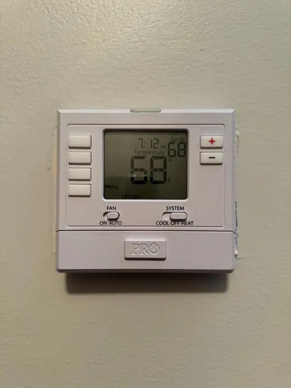 Wall thermostat displaying room temperature