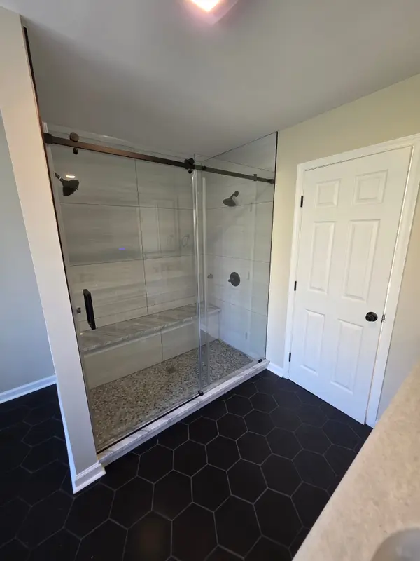 Finished walk-in shower with glass enclosure