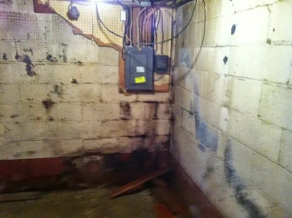 Basement wall showing water staining and moisture