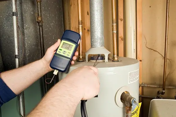 Technician testing a residential water heater