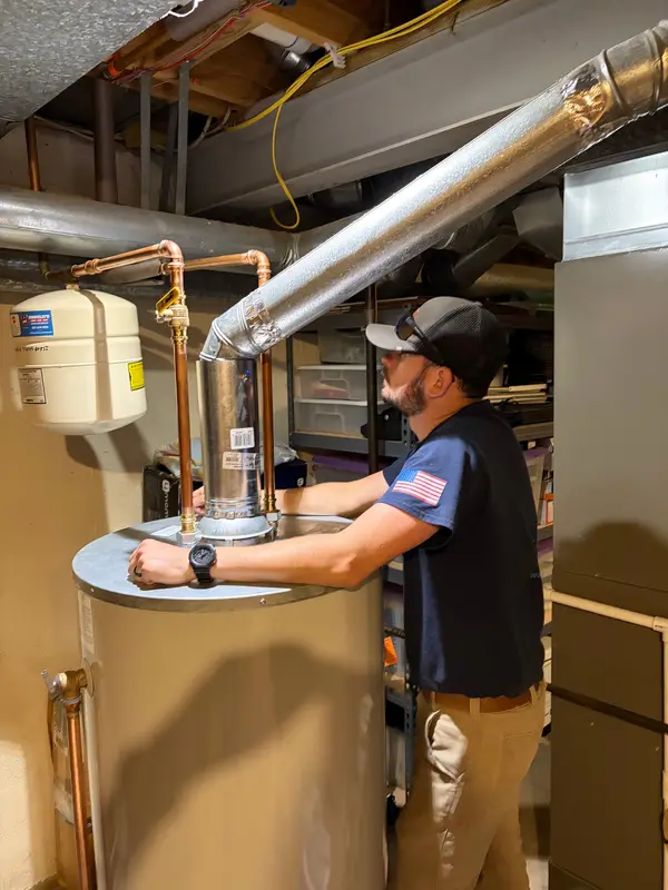 Technician servicing a residential water heater